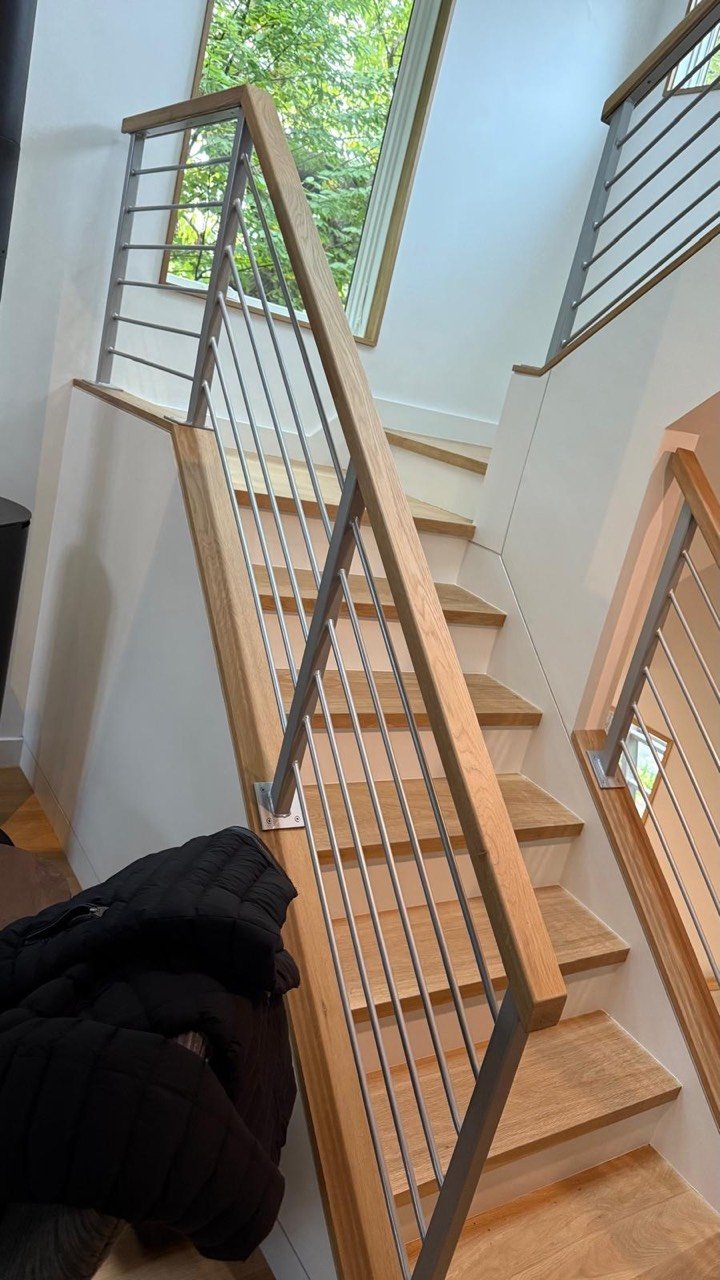 Steel stair railing with wood handrail