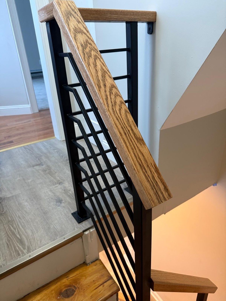 Wood handrail with black steel posts