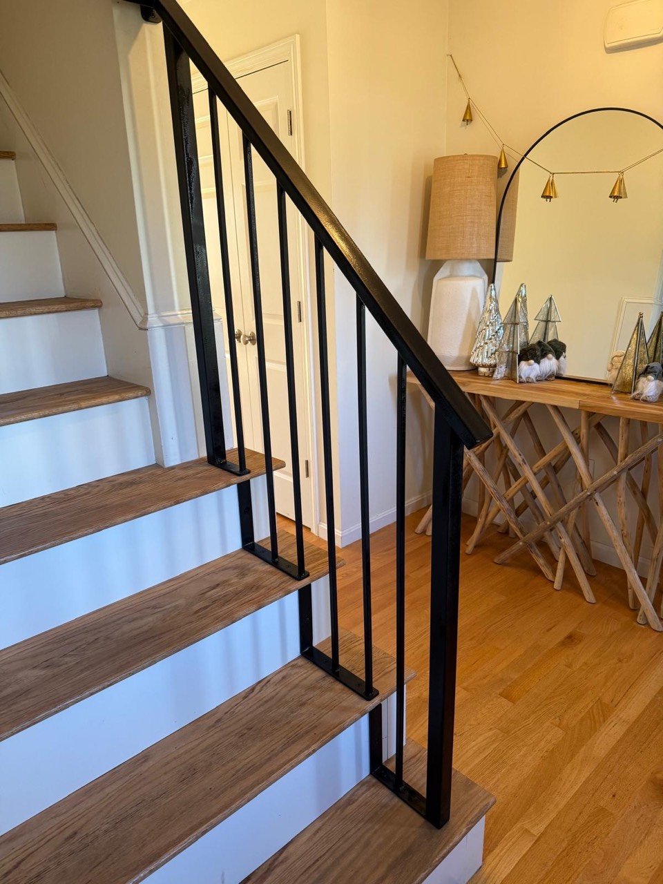 Black steel stair railing on a wood staircase