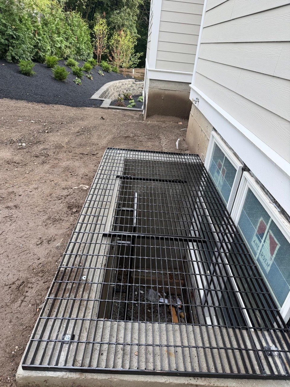 Steel grate over a basement window well